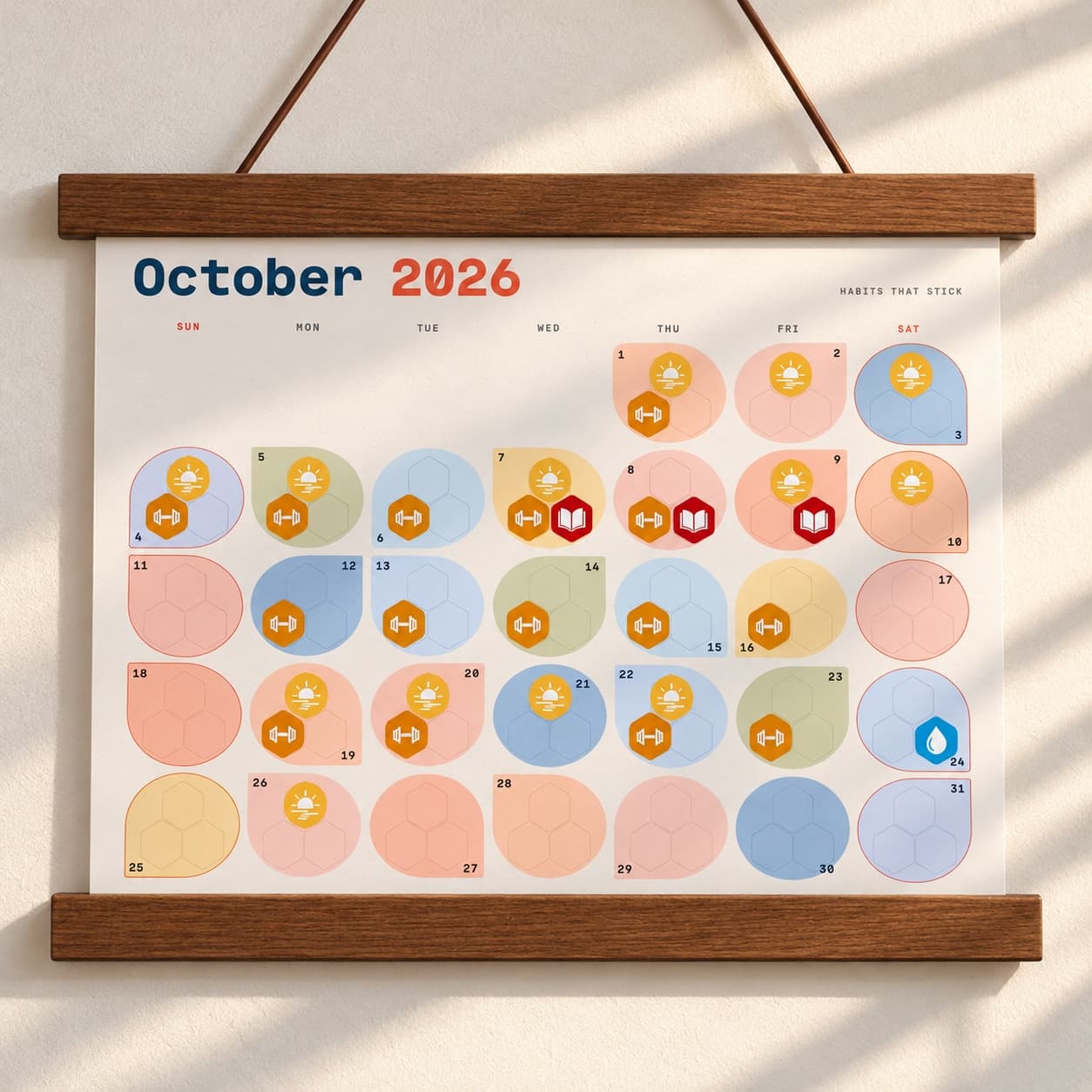 Stickto calendar in use with habit stickers and a wooden hanger; stickers and frame sold separately